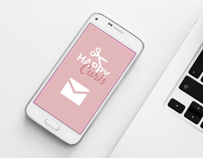 Image of phone and laptop with Happy Curls logo on it.